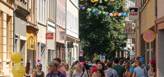 Menschen laufen eine Straße entlang.