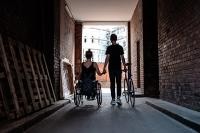 Wheelchair user and cyclist hand in hand. (Photo: Weiland)