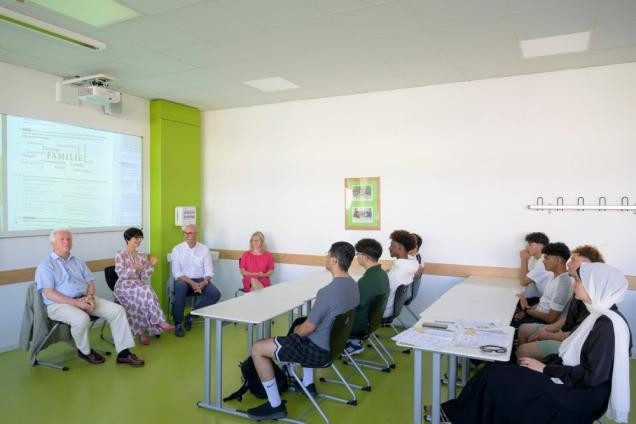 Bürgermeisterin Stefanie Jansen, Prof. Bernhard Eitel, Prof. Frieder Hepp und Claudia Emmendörfer-Brößler sitzen mit dem Schülerinnen und Schülern der Sommerschule im Unterrichtsraum.