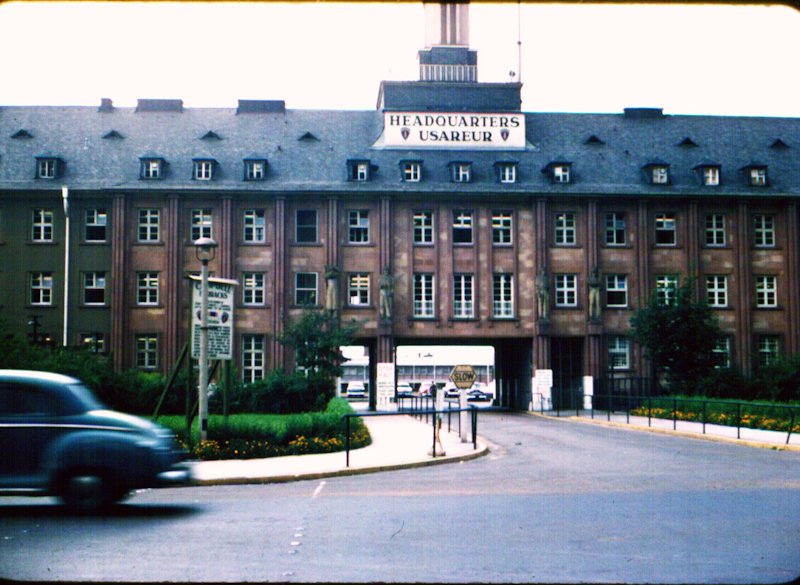 Headquarters of the US Army in Heidelberg in the 1950s. Photo by Bobby D. Buzbee The photo shows a film camera as a symbol on the left and a filmstrip on the right on which three scenes can be seen.