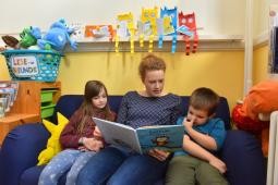 Stadt Heidelberg setzt bei der Personalgewinnung auf enge Zusammenarbeit mit den freien Trägern. (Foto: Peter Dorn) Frau liest zwei Kindern etwas vor