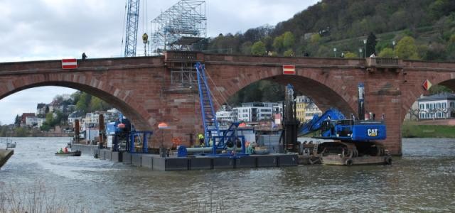 Die Alte Brücke heutzutage während der Pfeilersanierung durch ein Schiff.