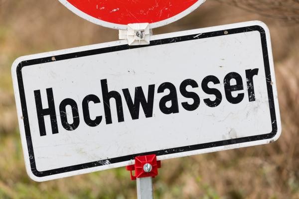Symbolbild Hochwasser. (Foto: Adobe) Ein Schild, auf dem "Hochwasser" steht.