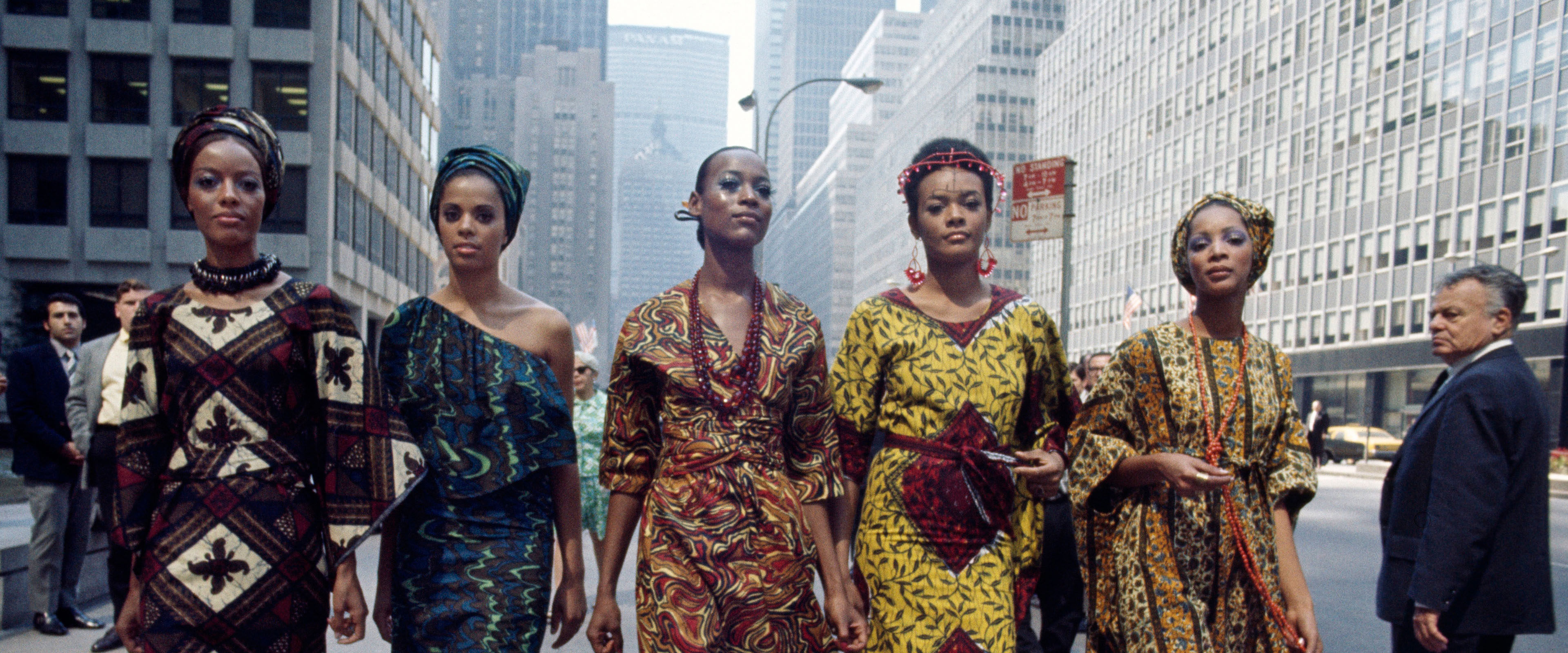 Fünf afrikanisch-amerikanische Models laufen zwischen Hochhäusern in Manhattan