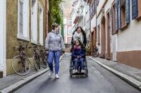 Eine Frau im Rollstuhl mit zwei anderen Frauen in der Altstadt unterwegs. (Foto: Pellner) 
