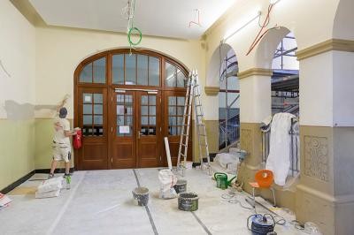 An der Marie-Marcks- und der Wilckensschule werden in den Sommerferien die Haupttreppenhäuser saniert – eine von zahlreichen Modernisierungsmaßnahmen, die in der schulfreien Zeit laufen. (Foto: Philipp Rothe) Handwerker verputzt Wand in historischem Treppenhaus