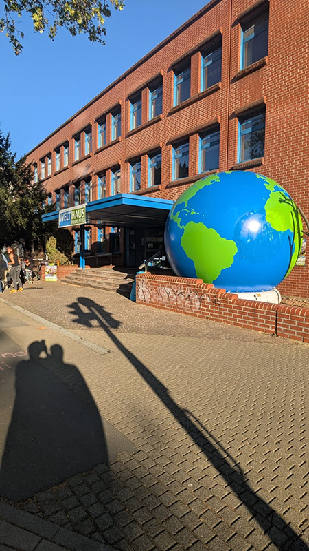 Große Weltkugel vor Backsteingebäude
